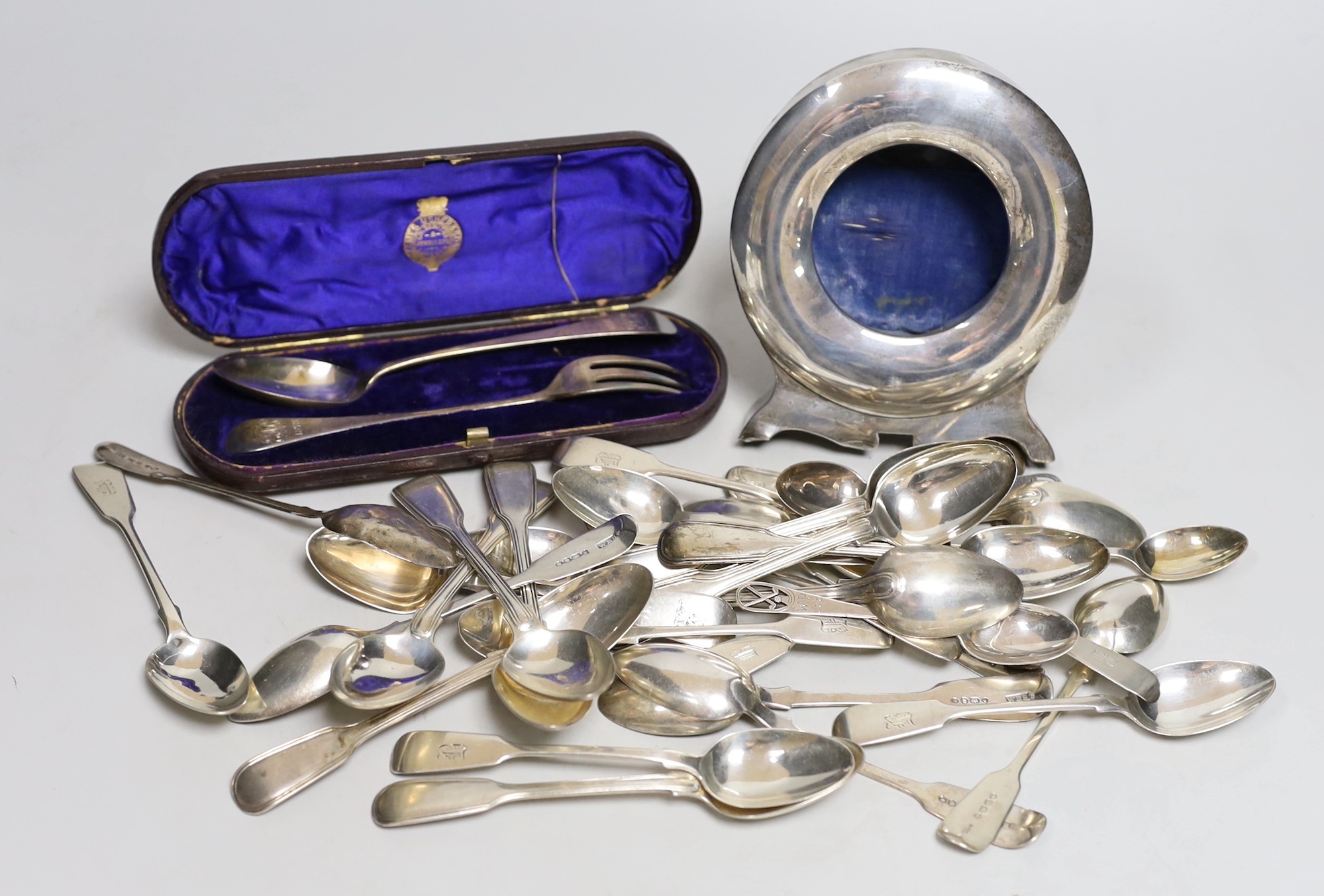 A set of eleven Victorian silver fiddle pattern teaspoons, Elizabeth Eaton, London, 1854/5, assorted other silver teaspoons, various dates and makers, a cased silver christening pair and a silver pocket watch travelling